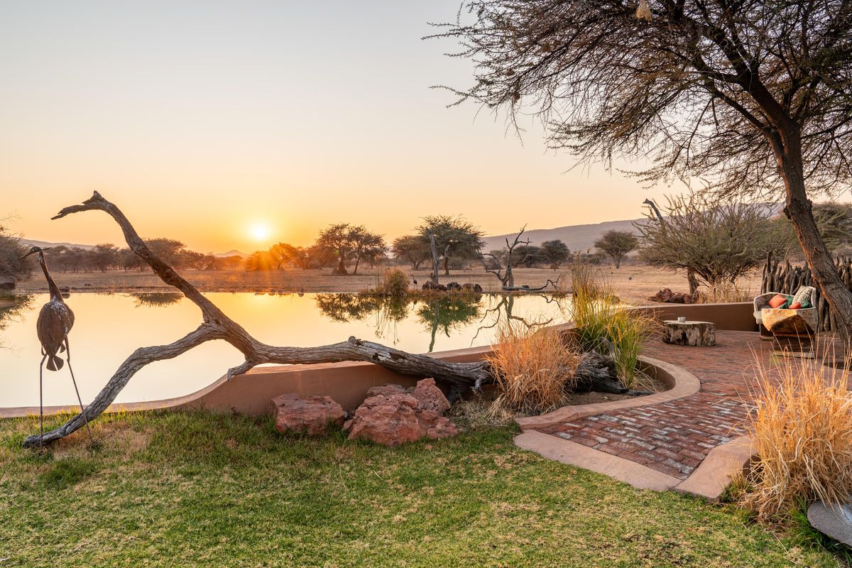 Okonjima Bush Camp waterhole sunset